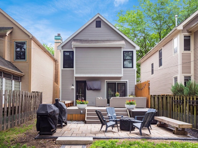 1243 Harrison Ave, Columbus, OH 43201 - rear view of property featuring a fire pit, a patio area, a fenced backyard, and a wooden deck