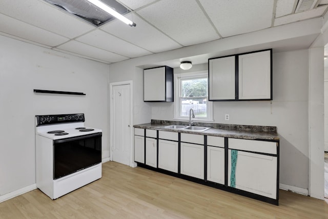 846 4th St, Lancaster, OH 43130 - kitchen featuring white electric range, a paneled ceiling, dark countertops, and light wood-style floors