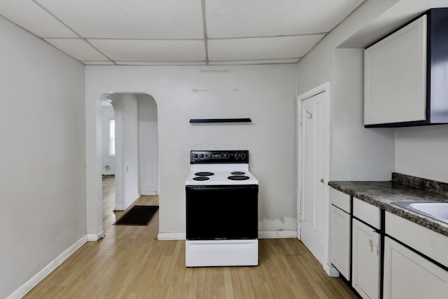 846 4th St, Lancaster, OH 43130 - kitchen featuring white electric range oven, a paneled ceiling, dark countertops, arched walkways, and light wood-type flooring