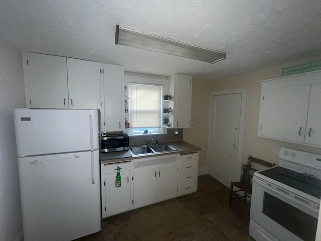 85 Landers Ave, Columbus, OH 43207 - kitchen featuring white appliances, white cabinets, a textured ceiling, and dark countertops