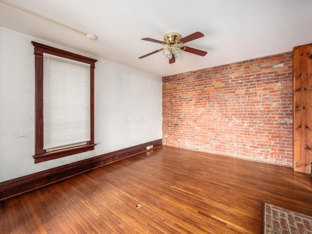 1360 S High St, Columbus, OH 43207 - unfurnished room featuring brick wall, a ceiling fan, and wood-type flooring