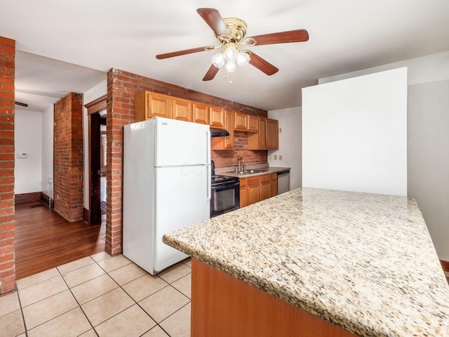 1360 S High St, Columbus, OH 43207 - kitchen with freestanding refrigerator, electric range, stainless steel dishwasher, ceiling fan, and under cabinet range hood