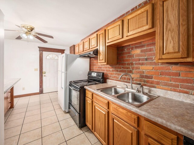 1360 S High St, Columbus, OH 43207 - kitchen with black electric range, under cabinet range hood, light tile patterned flooring, ceiling fan, and light countertops
