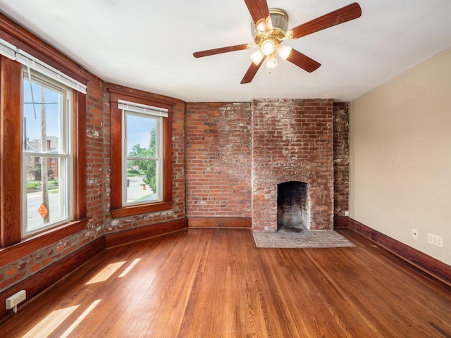 1360 S High St, Columbus, OH 43207 - unfurnished living room with wood finished floors, a ceiling fan, and a fireplace