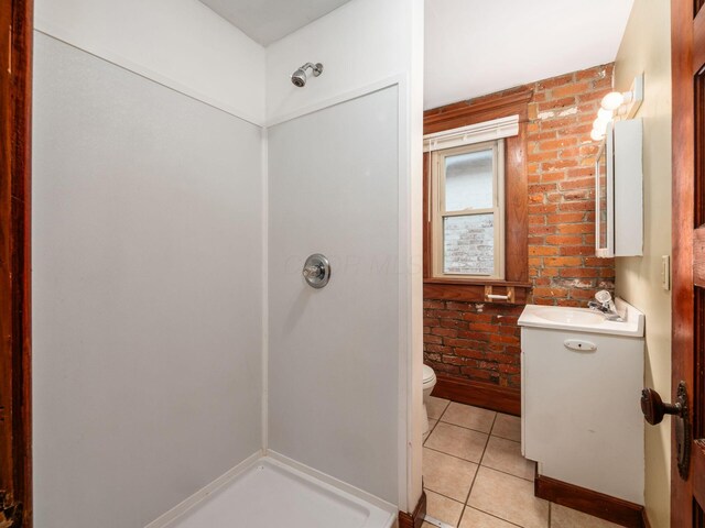 1360 S High St, Columbus, OH 43207 - bathroom with vanity, tile patterned floors, a shower, and brick wall