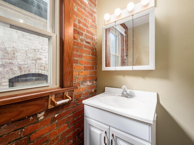 1360 S High St, Columbus, OH 43207 - bathroom featuring brick wall and vanity
