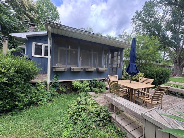 1470 S Riverview Rd, Malta, OH 43758 - back of house featuring a wooden deck, outdoor dining area, and a sunroom