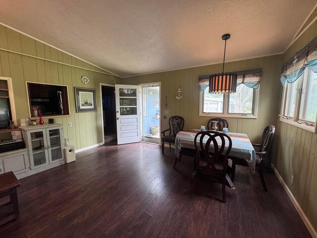 1470 S Riverview Rd, Malta, OH 43758 - dining room featuring a textured ceiling, wood finished floors, vaulted ceiling, crown molding, and wooden walls