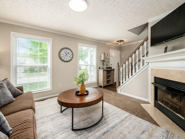 3538 Rosburg Dr, Columbus, OH 43228 - carpeted living room featuring stairway, a textured ceiling, ornamental molding, and a tile fireplace