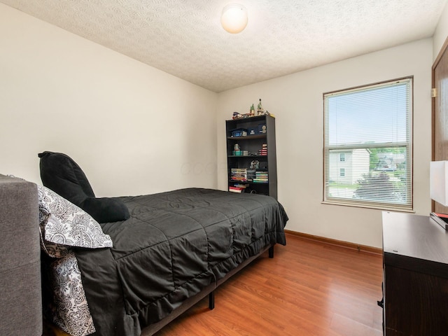 3538 Rosburg Dr, Columbus, OH 43228 - bedroom with light wood-style flooring and a textured ceiling