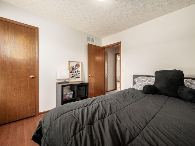 3538 Rosburg Dr, Columbus, OH 43228 - bedroom with wood finished floors and a textured ceiling