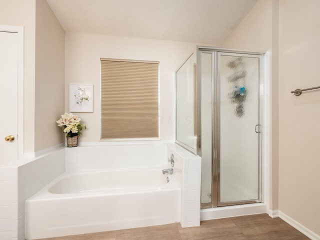 3538 Rosburg Dr, Columbus, OH 43228 - full bath featuring a stall shower, a garden tub, and wood finished floors