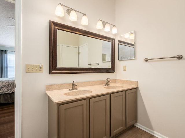 3538 Rosburg Dr, Columbus, OH 43228 - full bath with double vanity, connected bathroom, and wood finished floors