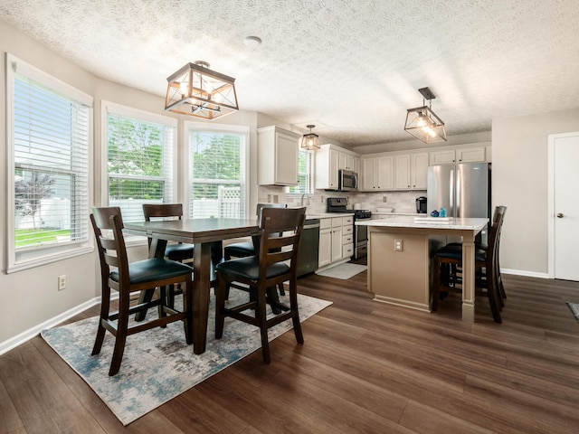 3538 Rosburg Dr, Columbus, OH 43228 - dining space featuring a textured ceiling, a chandelier, and dark wood finished floors