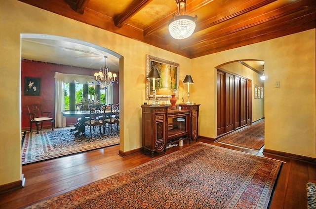 2475 Signal Hill Rd, Springfield, OH 45504 - foyer entrance featuring a chandelier, arched walkways, wood-type flooring, and a wood ceiling with exposed beams