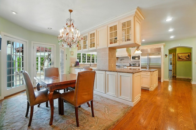 2475 Signal Hill Rd, Springfield, OH 45504 - dining room featuring arched walkways, healthy amount of natural light, light wood-style flooring, recessed lighting, and a chandelier