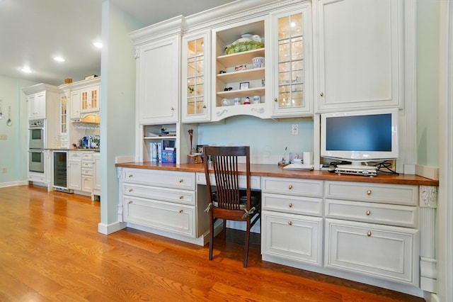 2475 Signal Hill Rd, Springfield, OH 45504 - office area with beverage cooler, built in desk, light wood-style floors, and recessed lighting