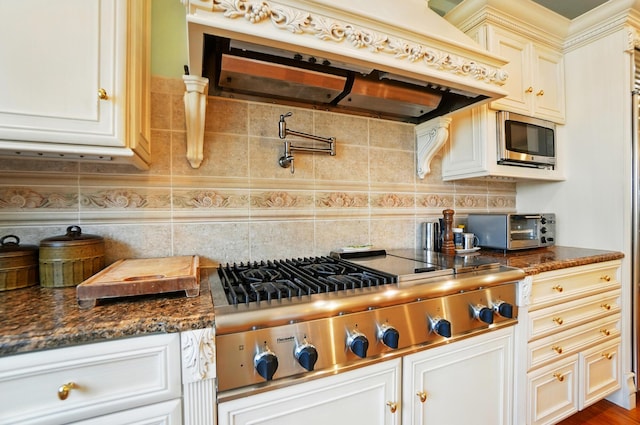 2475 Signal Hill Rd, Springfield, OH 45504 - kitchen featuring appliances with stainless steel finishes, exhaust hood, backsplash, and dark stone countertops