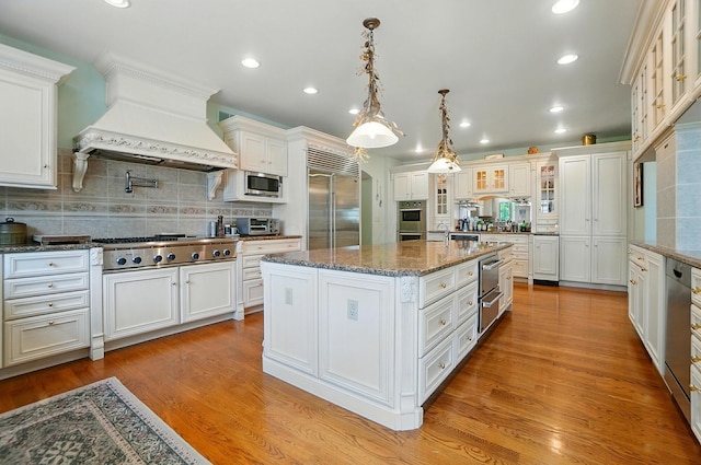 2475 Signal Hill Rd, Springfield, OH 45504 - kitchen featuring stainless steel appliances, custom range hood, a center island, white cabinetry, and recessed lighting