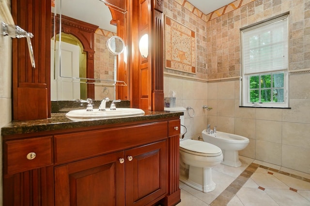 2475 Signal Hill Rd, Springfield, OH 45504 - bathroom with a bidet, tile patterned flooring, tile walls, inlaid floor details, and vanity