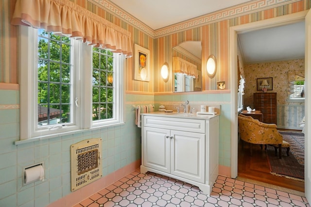 2475 Signal Hill Rd, Springfield, OH 45504 - kitchen with wallpapered walls, heating unit, plenty of natural light, and white cabinetry