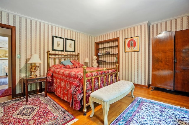 2475 Signal Hill Rd, Springfield, OH 45504 - bedroom with ornamental molding, wallpapered walls, and wood finished floors