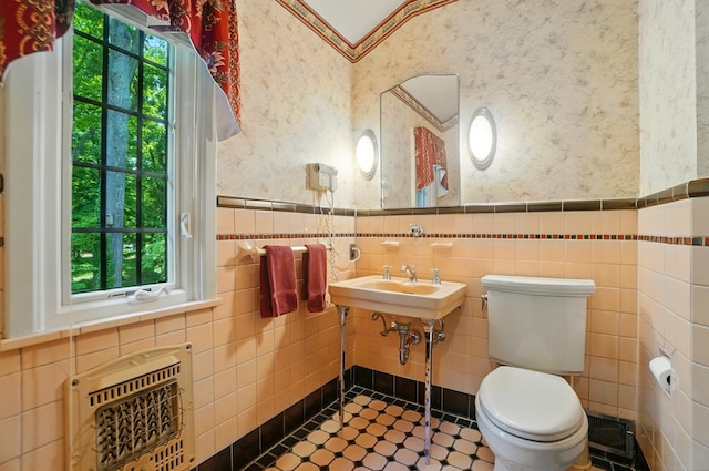 2475 Signal Hill Rd, Springfield, OH 45504 - half bathroom with heating unit, wallpapered walls, wainscoting, plenty of natural light, and tile walls