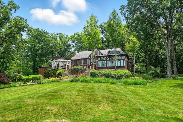 2475 Signal Hill Rd, Springfield, OH 45504 - rear view of property featuring stairway, a pergola, a yard, and a chimney