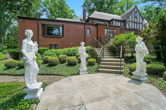 2475 Signal Hill Rd, Springfield, OH 45504 - rear view of property with brick siding, a chimney, and stairway