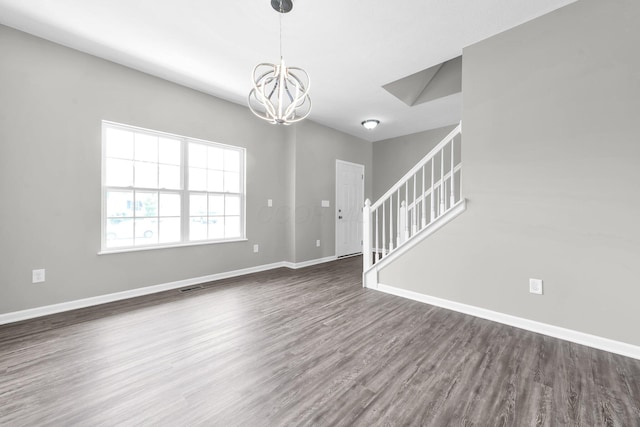 166 Rosewood Loop SE, Commercial Point, OH 43116 - spare room featuring a chandelier, dark wood-style flooring, and stairway