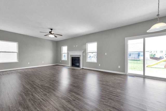 166 Rosewood Loop SE, Commercial Point, OH 43116 - unfurnished living room featuring dark wood-type flooring, ceiling fan, and a premium fireplace