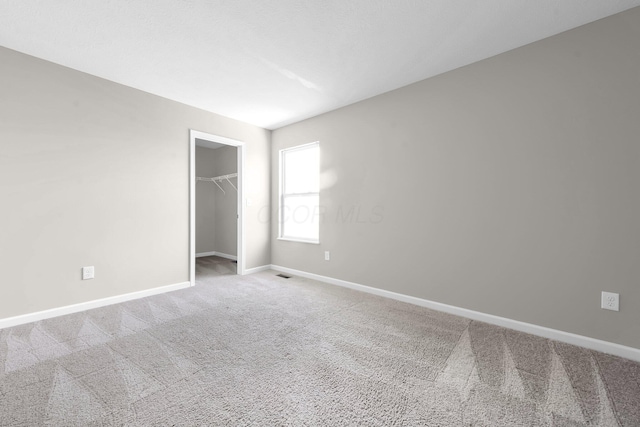 166 Rosewood Loop SE, Commercial Point, OH 43116 - unfurnished bedroom with carpet flooring, a spacious closet, and a closet