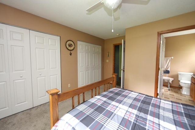264 Ridgeway Dr, Howard, OH 43028 - bedroom featuring multiple closets, ensuite bathroom, a ceiling fan, and light colored carpet
