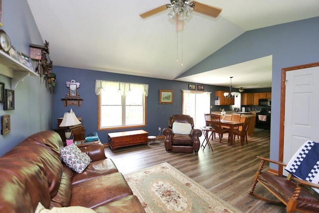 264 Ridgeway Dr, Howard, OH 43028 - living area with vaulted ceiling, plenty of natural light, wood finished floors, ceiling fan, and a chandelier