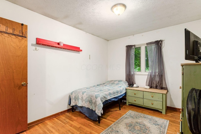6103 Renner Rd, Columbus, OH 43228 - bedroom featuring light wood-type flooring and a textured ceiling