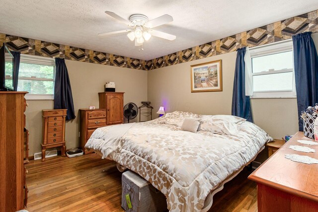 6103 Renner Rd, Columbus, OH 43228 - bedroom featuring hardwood / wood-style floors, a textured ceiling, and a ceiling fan