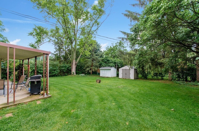 6103 Renner Rd, Columbus, OH 43228 - view of green lawn with a storage unit and a patio area