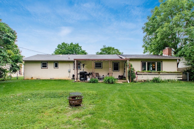 6103 Renner Rd, Columbus, OH 43228 - rear view of house featuring an outdoor fire pit, a chimney, a patio, and brick siding