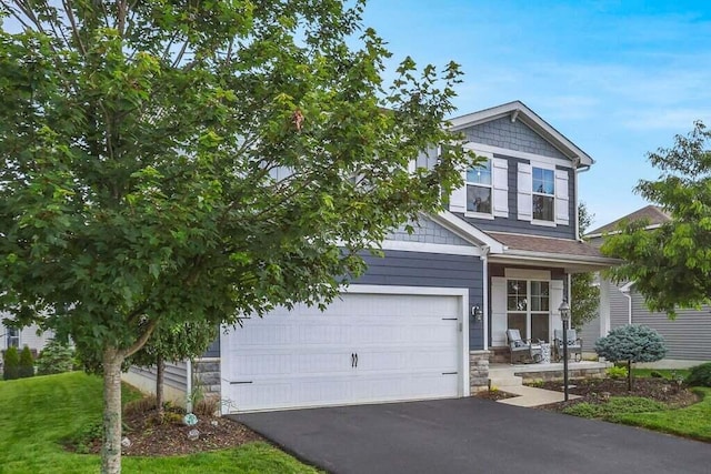 117 Sparrow Ct, Pickerington, OH 43147 - view of front of house featuring stone siding, asphalt driveway, and a garage