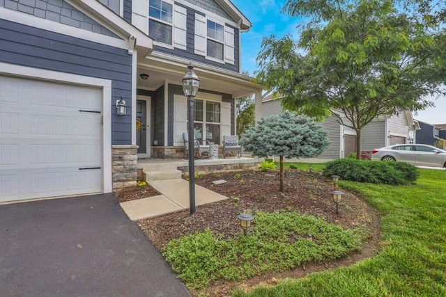 117 Sparrow Ct, Pickerington, OH 43147 - entrance to property featuring covered porch, driveway, and stone siding