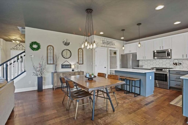 117 Sparrow Ct, Pickerington, OH 43147 - dining room featuring recessed lighting, a chandelier, dark wood finished floors, and stairway