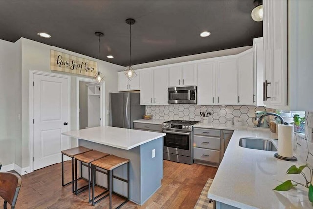 117 Sparrow Ct, Pickerington, OH 43147 - kitchen featuring stainless steel appliances, a kitchen island, a kitchen bar, light countertops, and tasteful backsplash