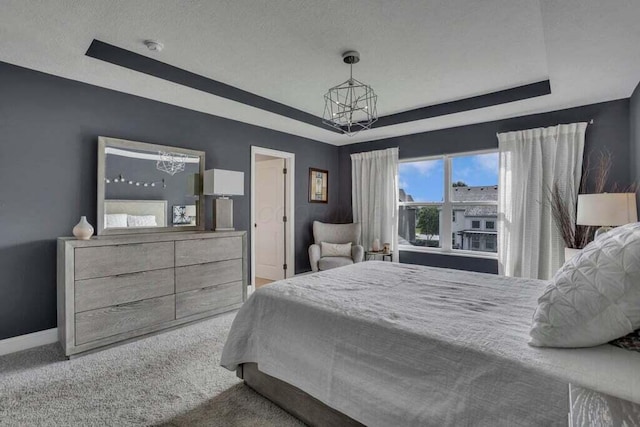 117 Sparrow Ct, Pickerington, OH 43147 - carpeted bedroom featuring a raised ceiling and a chandelier