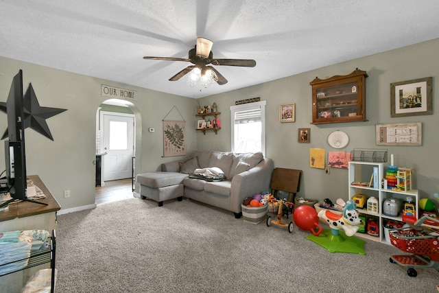714 N Main St, Baltimore, OH 43105 - carpeted living room with ceiling fan, arched walkways, and a textured ceiling