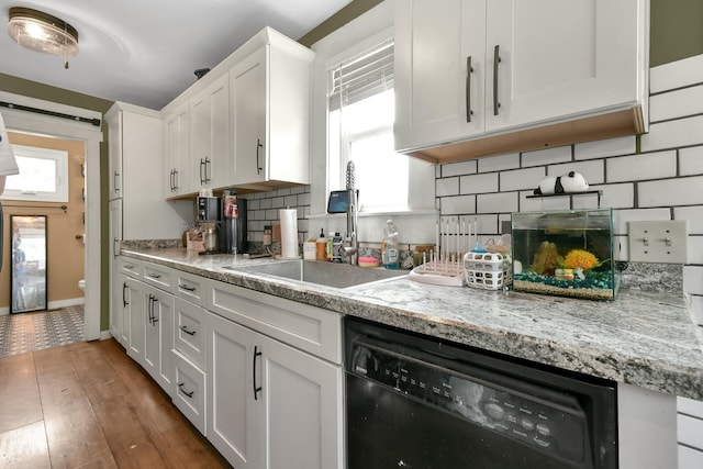 714 N Main St, Baltimore, OH 43105 - kitchen featuring dishwasher, white cabinetry, decorative backsplash, wood finished floors, and light stone countertops