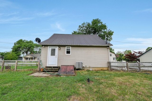 714 N Main St, Baltimore, OH 43105 - back of property with entry steps, a fenced backyard, and a metal roof