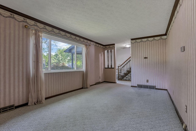 2809 Bella Via Ave, Columbus, OH 43231 - unfurnished living room with a textured ceiling, stairs, crown molding, carpet floors, and wallpapered walls
