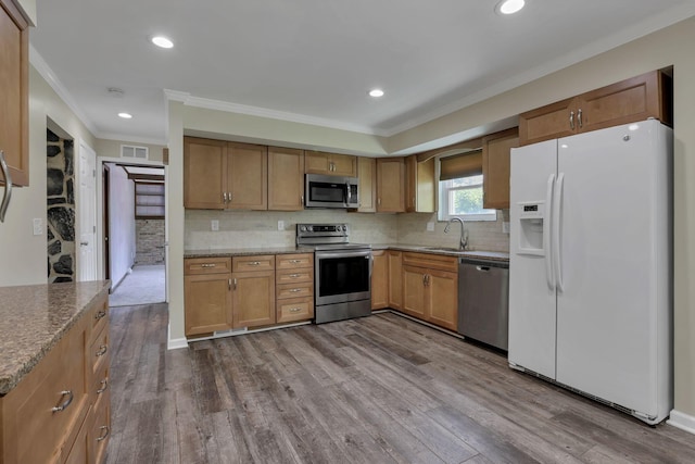 2809 Bella Via Ave, Columbus, OH 43231 - kitchen featuring appliances with stainless steel finishes, crown molding, dark wood-type flooring, stone counters, and decorative backsplash
