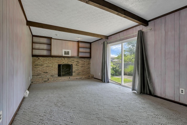 2809 Bella Via Ave, Columbus, OH 43231 - unfurnished living room with a textured ceiling, beam ceiling, wood walls, a brick fireplace, and carpet flooring