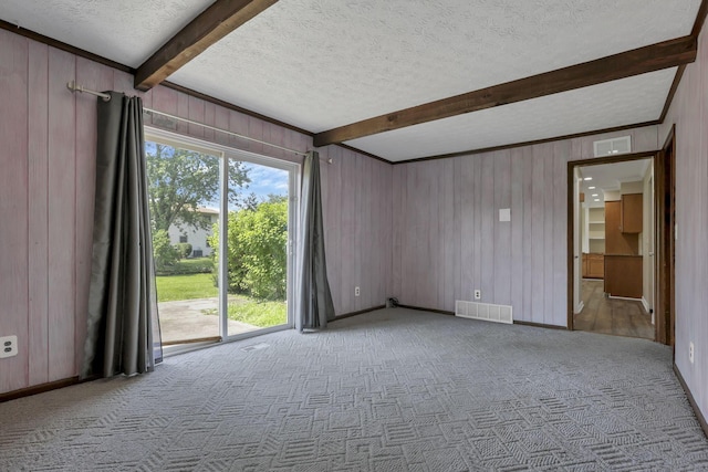 2809 Bella Via Ave, Columbus, OH 43231 - empty room featuring beam ceiling, a textured ceiling, carpet flooring, and wood walls
